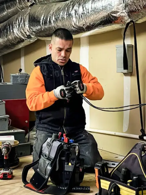 A Lieber Mech technician working on an HVAC install.
