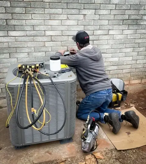 HVAC service being conducted on a customer's air conditioning unit in Yukon.